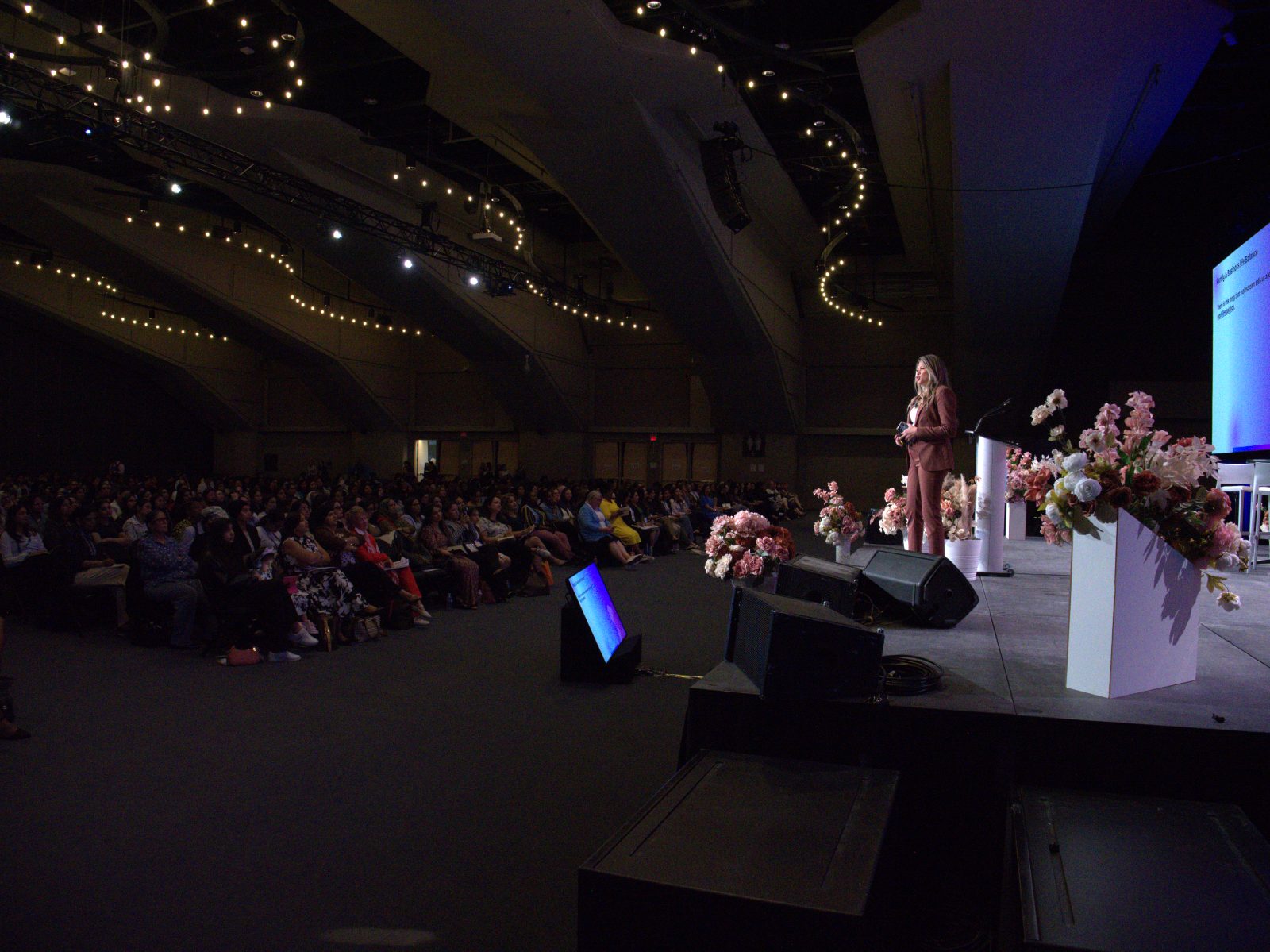 Nelizze on stage, delivering a keynote